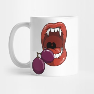 Mouth with vampire teeth about to take a bite into a purple grape Mug